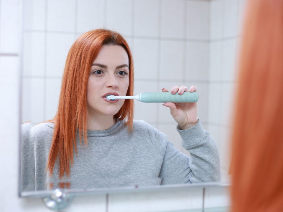 woman brushing her teeth